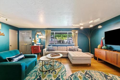 a living room with a couch and a tv at The East End Retreat in Boise