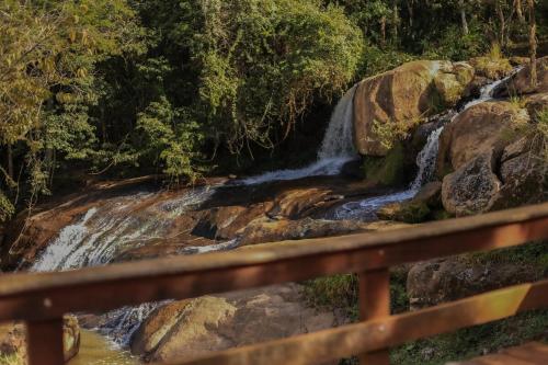 a waterfall on the side of a river at Cascata dos Rocha in Conceição dos Ouros