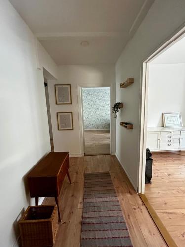 a hallway with a table and a door to a room at The Modern Fifties in Rovaniemi