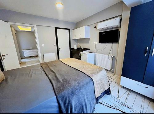 a bedroom with a bed and a small kitchen at Otantik Taksim Hotel in Istanbul
