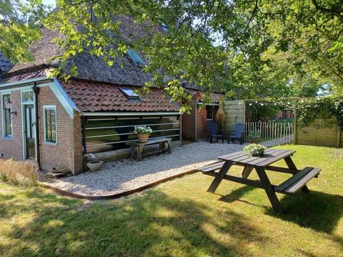 a backyard with a picnic table and a house at Boerderij Blok in Barsingerhorn