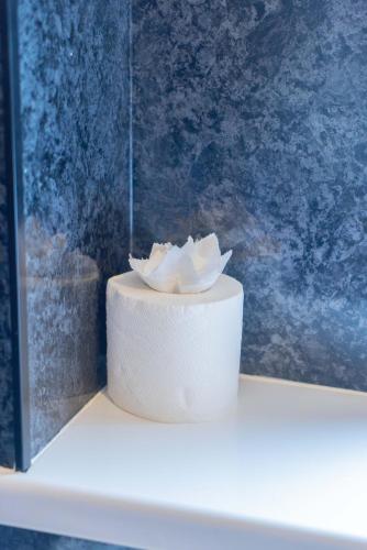 a white cake with a flower on top of it at Rydal Retreat in Carlisle