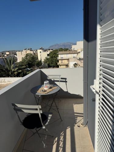 a patio with a table and chairs on a balcony at Creta Apt Mela Β6 in Thérissos