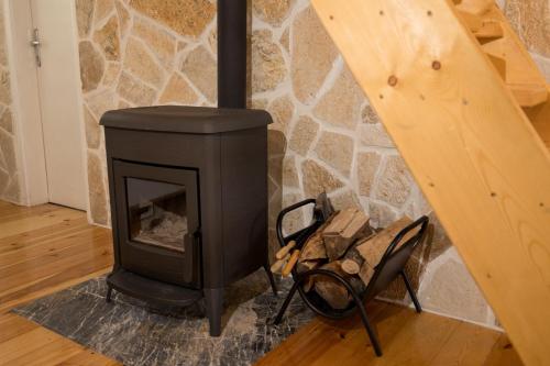 a wood stove in a room with a staircase at Žabljak- FamilyOasis in Žabljak