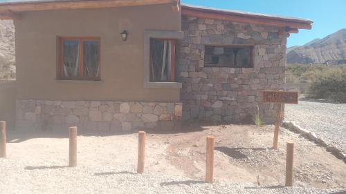 a building with a sign in front of it at Cabañas La Nochera in Tilcara