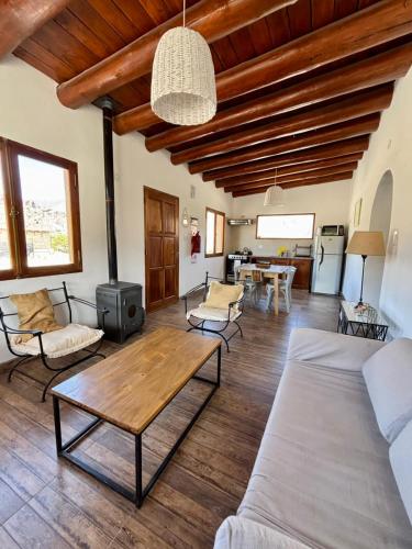 a living room with a couch and a table at Cabañas La Nochera in Tilcara