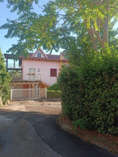a white house with a gate in front of it at Al girone in Spezzano Piccolo