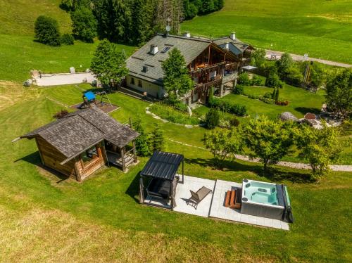 an aerial view of a house with a swimming pool and a yard at Alpine Mountain Chalet in San Vigilio Di Marebbe