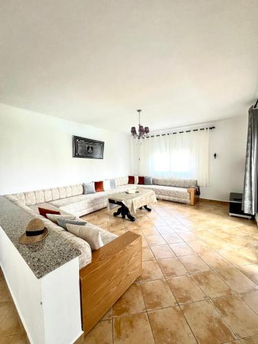a living room with a couch and a table at Relax Island in Oued Laou