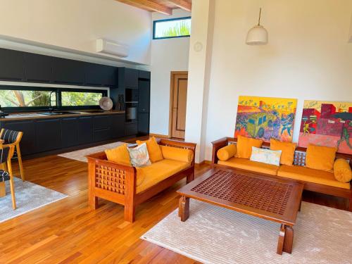 a living room with two couches and a table at Villa Ela - Cape of Rodon in Draçi