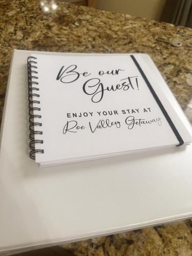 a notebook sitting on top of a table at Roe Valley Getaway in Limavady