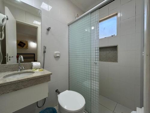 a bathroom with a toilet and a glass shower at diRoma International Resort - BT in Caldas Novas