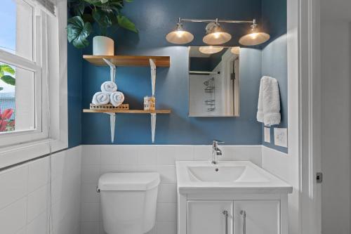 a bathroom with a white toilet and a sink at Smyrna Sol in New Smyrna Beach