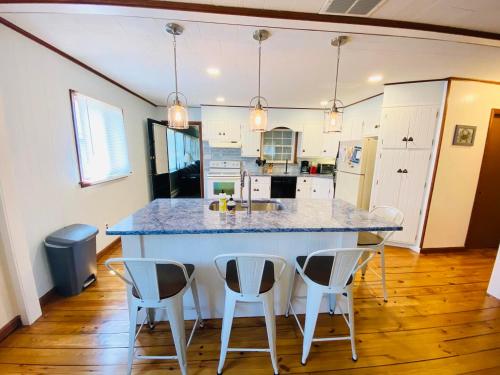a kitchen with a large island with four chairs at Bayard avenue 1603 in Dewey Beach
