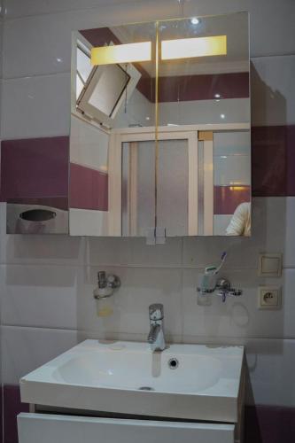 a bathroom with a sink and a mirror at Arina beach martil in Martil