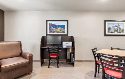 a waiting room with a computer and a chair at My Place Hotel-Bentonville-Rogers, AR in Bentonville