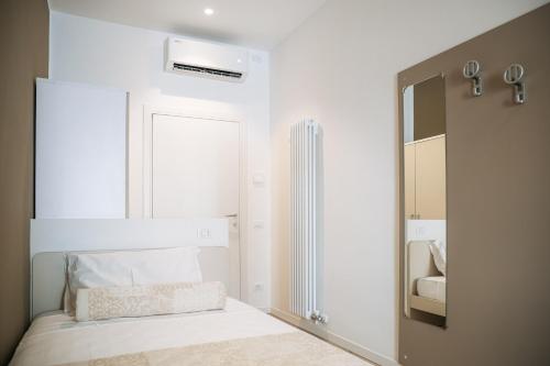 a white bedroom with a bed and a mirror at Studio Venice Mestre Centrale in Venice