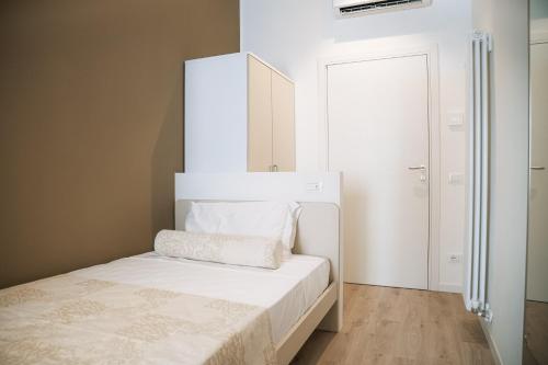 a small bedroom with a bed with a white headboard at Studio Venice Mestre Centrale in Venice