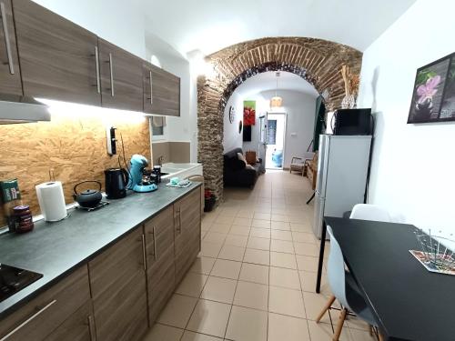 a kitchen with a counter and a living room at appartement centre historique in Bastia