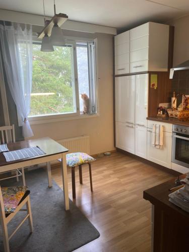 a kitchen with a table and a window at Huhtiniemenranta in Lappeenranta
