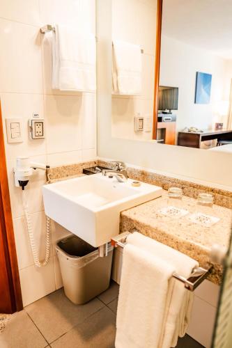 a bathroom with a sink and a mirror at Novotel Lima San Isidro in Lima