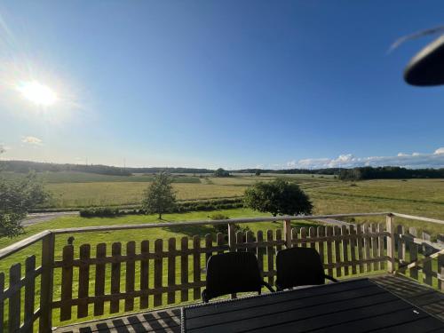 a view from the deck of a house with chairs at Svarteborg Dingle in Dingle