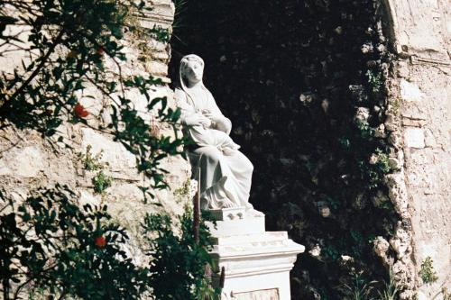 a statue of a man sitting on a wall at Hôtel du Couvent, a Luxury Collection Hotel, Nice in Nice