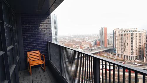 a chair on a balcony with a view of a city at London Iconic View Retreat in London