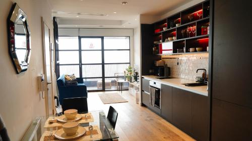 a kitchen with a dining table and a counter top at London Iconic View Retreat in London