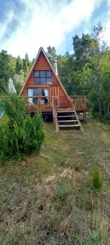 a cabin in the middle of a field at Refugio de Montaña Patagonia, pesca, trekking, miradores in Llanada Grande