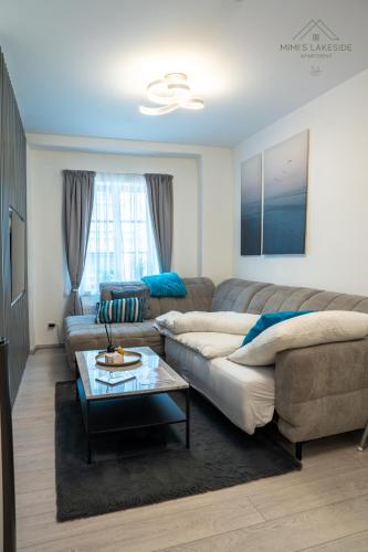a living room with a couch and a table at MIMIs Lakeside Apartment - NEWLY RENOVATED in Gmunden
