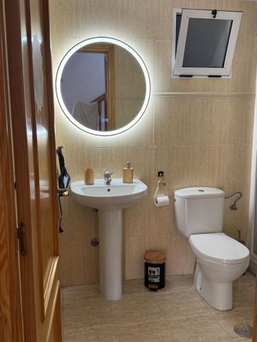 a bathroom with a sink and a toilet and a mirror at vera home shine in Vera