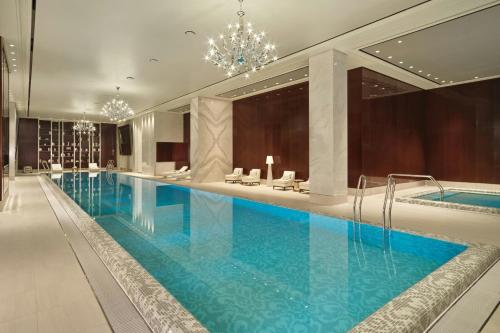 a large swimming pool in a hotel with a chandelier at Courtyard by Marriott Pyeongtaek in Pyeongtaek