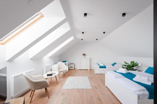 a white room with a bed and a couch at Chalupa Kozárovice in KozÃ¡rovice