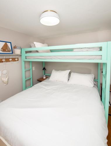 a bedroom with two bunk beds with white pillows at Cape Cod Cottage by Leavetown Vacations in Dennis Port