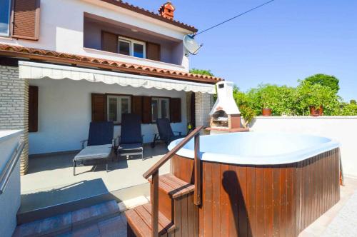 a bath tub on a balcony of a house at Holiday home in Manjadvorci - Istrien 8277 in Manjadvorci