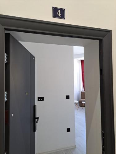 an elevator door with the number four sign on it at NEW - Old Town Pearl Apartments in Sarajevo