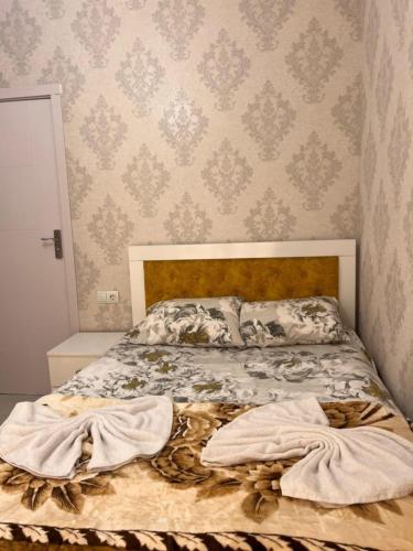 a bed with two blankets on it in a bedroom at Comfortable 5 rooms apartment in Kutaisi