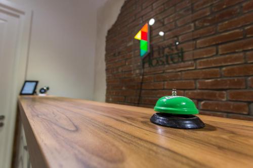 a green helmet sitting on top of a wooden counter at First Hostel in Bucharest