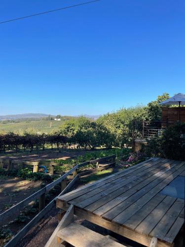 a wooden deck with a view of a field at Honeymoon Stay at The James Family Farm in Grabouw