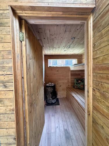 a wooden sauna with a wooden floor and a window at Honeymoon Stay at The James Family Farm in Grabouw