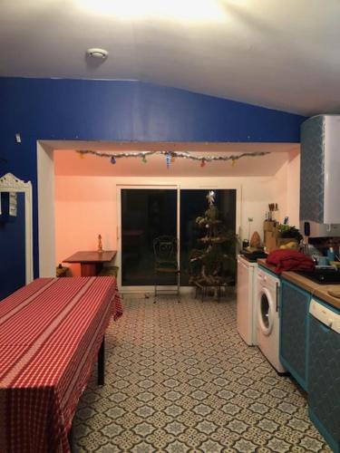 a kitchen with a christmas tree in the corner of a room at MAISON AVEC JARDIN - 2 logements et entrées distincts et indépendantes in Saint-Paimboeuf
