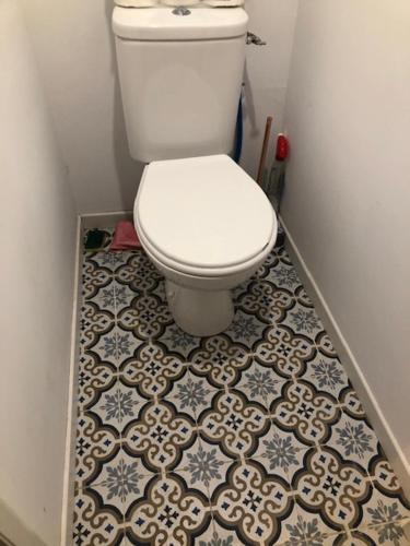 a bathroom with a toilet and a tile floor at MAISON AVEC JARDIN - 2 logements et entrées distincts et indépendantes in Saint-Paimboeuf