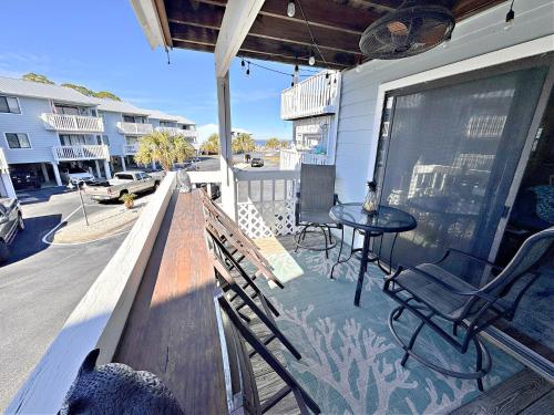 a patio with a table and chairs on a balcony at Bayview in Orange Beach