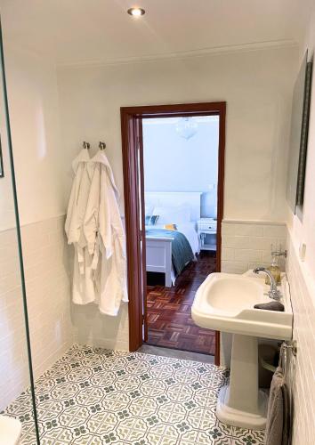 a bathroom with a sink and a shower and a sink at The Cão & Calf in Faja Grande