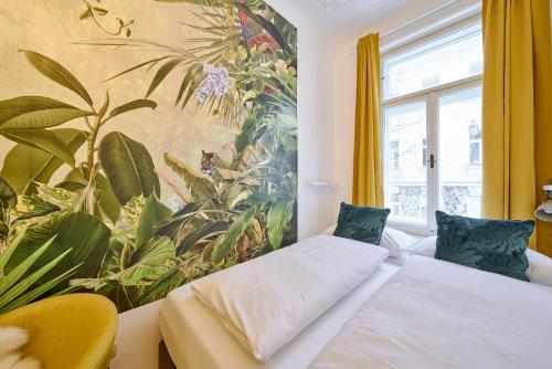 a room with two beds and a large painting on the wall at Leuhusen Collection Vienna, Wien in Vienna