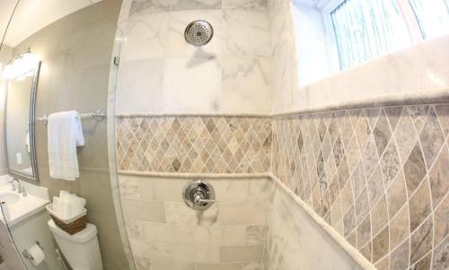 a bathroom with a shower with a toilet and a sink at Upscale 6 Bed, 5 Ba, New Pool W/Jacuzzi, 1/2 Mile Walk to Disney in Anaheim
