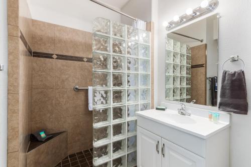 a bathroom with a sink and a shower with a mirror at Southern #1064 Mesa in Mesa