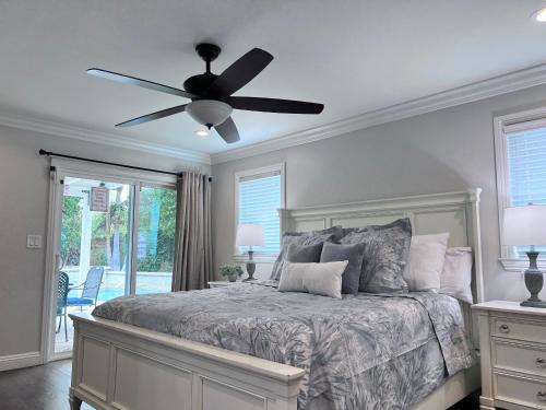 a bedroom with a bed with a ceiling fan at Fabulous 6 bedroom (3 master suites), 4 bath pool w/Jacuzzi home in Orange