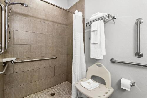 a bathroom with a toilet and a shower at Quality Inn Shallotte near Ocean Isle Beach in Shallotte